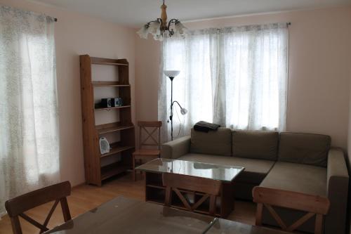 a living room with a couch and a table at Коттедж в Финляндии, Enonkoski (розовый) in Enonkoski