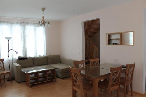 a living room with a couch and a table at Коттедж в Финляндии, Enonkoski (розовый) in Enonkoski