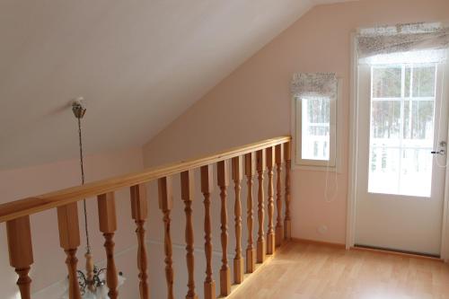 a room with a staircase and a window at Коттедж в Финляндии, Enonkoski (розовый) in Enonkoski