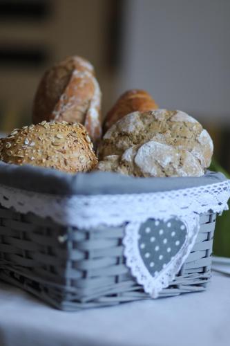 un panier de différents types de pain sur une table dans l'établissement Residence Alpenrose, à Bressanone