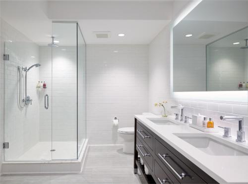a bathroom with a shower, sink, and toilet at Isla Bella Beach Resort & Spa - Florida Keys in Marathon