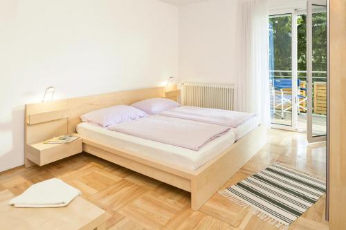 Posteľ alebo postele v izbe v ubytovaní Apartments Hauskaernten