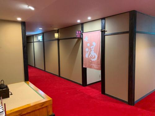 a row of lockers in a room with a red carpet at Ryokan Murayama in Takayama
