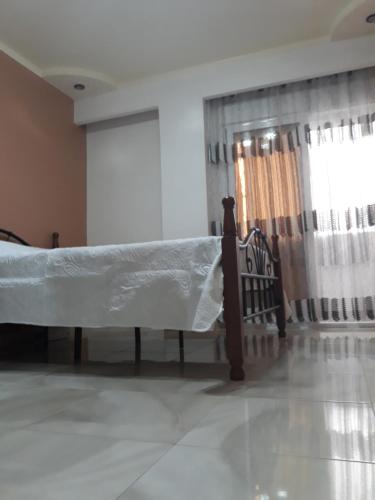 a bedroom with a bed with a sheet on it at Appartement Akid Lotfi Oran in Oran