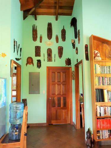 a room with a door and some masks on the wall at Slo-N-Ez Villa Terrace (Ocean View) in Caye Caulker