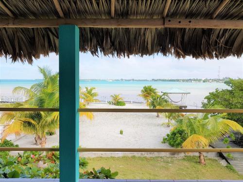 a view of the beach from a resort window at Slo-N-Ez Villa Terrace (Ocean View) in Caye Caulker