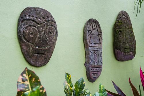 three pieces of artifact hanging on a wall at Tico Tico Villas - Adult Only in Manuel Antonio