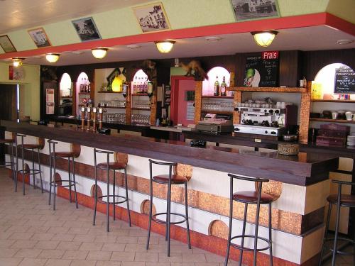 a bar in a restaurant with stools at Le Toul' Broch in Baden