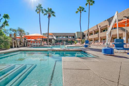 a swimming pool with palm trees and a hotel at Scottsdale Parkview in Scottsdale