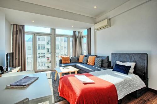 a living room with a bed and a couch at Alameda Flat in Lisbon