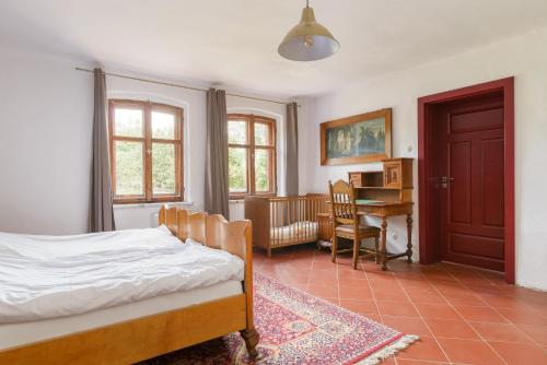 a bedroom with a bed and a desk at Rokitnica 37 in Niesulice