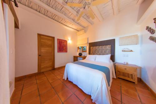 a bedroom with a large bed in a room at Mi Otra Casa in Sayulita