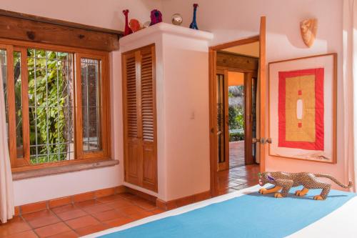 a hallway with a blue rug in a house at Mi Otra Casa in Sayulita