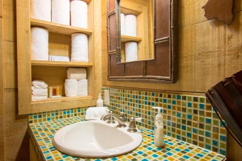 a bathroom with a sink and a mirror at Beautiful 1 BR "Barn" Cabin - Perfect for Small Families in Panguitch