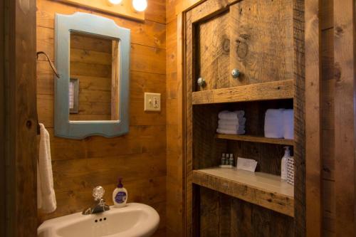 a bathroom with a sink and a mirror at Secluded 1 Bedroom Cabin on 50 Acres of Land in Panguitch