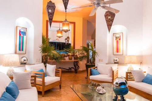 a living room with white couches and a table at Mi Otra Casa in Sayulita
