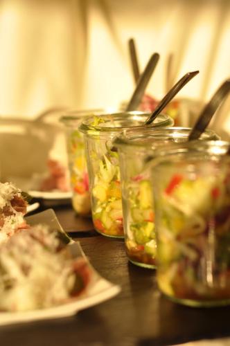a table with several jars of food on a table at Hotel-Restaurant Minichmayr in Steyr