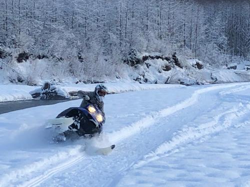 a person on a snowboard in the snow at Historic Hotel Bayview in Stewart