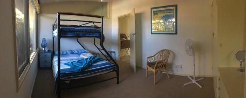 a room with two bunk beds and a chair at Relax at Tranquil Rye short walk to beach & shops in Rye