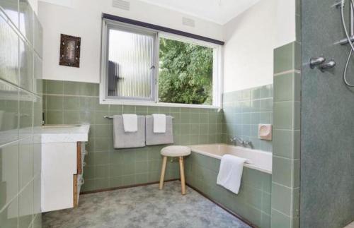 a bathroom with a sink and a tub and a window at Relax at Tranquil Rye short walk to beach & shops in Rye