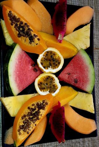 a plate of fruit with different types of fruits at Kanalu Studio in Bouillante