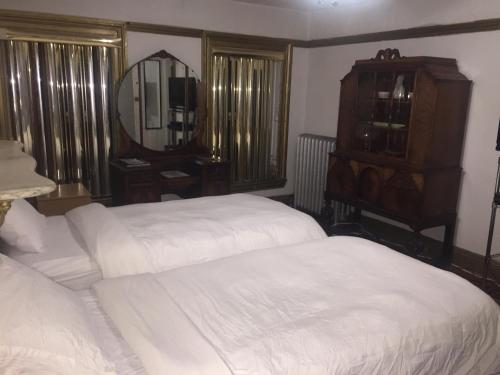 a bedroom with a bed and a dresser at Illumination Bed & Breakfast in Brooklyn