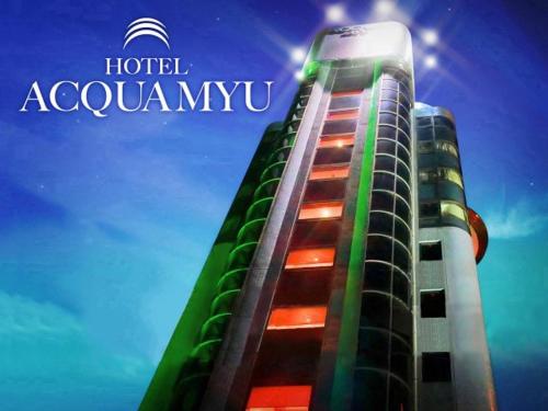 a tall building with a sign on top of it at Hotel ACQUA MYU in Fukuoka