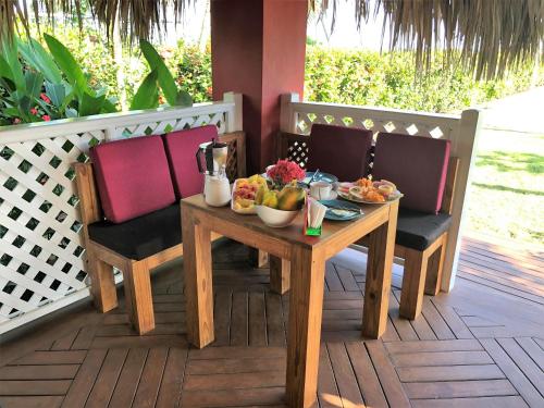 a table with a bowl of fruit on a porch at Casa Azul Las Galeras in Las Galeras
