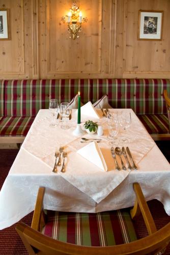 a table with a white table cloth and a candle on it at Alpenresort Fluchthorn in Galtür