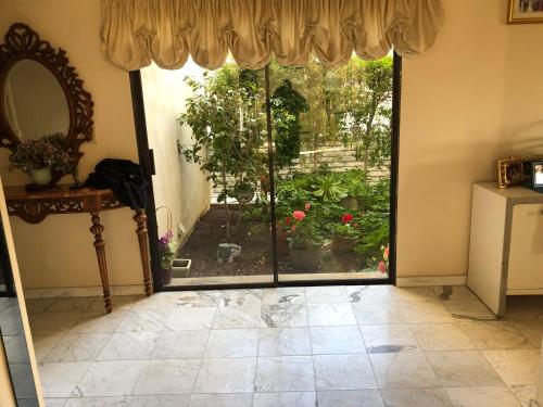 an open door with a view of a garden at Hollywood Hills private room in Los Angeles