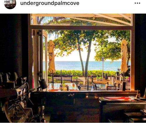 a view of the ocean from a restaurant window at Sarayi Boutique Hotel in Palm Cove