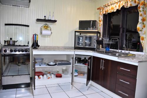 a kitchen with a stove and a counter top at La Casita Amarilla in Futrono