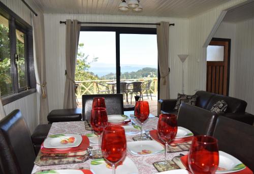 a dining room table with red wine glasses on it at La Casita Amarilla in Futrono