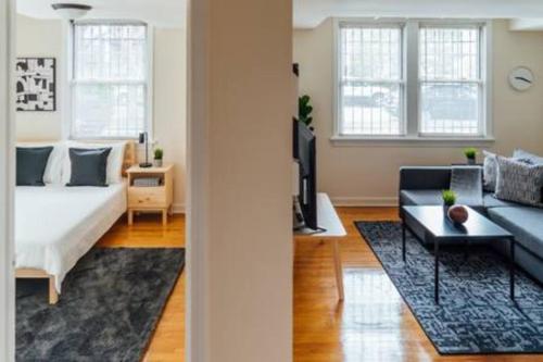 a living room with a bed and a couch at Calm & Well-Equipped 2BR Chicago Apartment - Central Cozy in Dunning