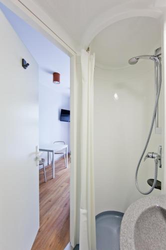 a bathroom with a shower and a sink at Just Rest Automatic Hostel in Viljandi