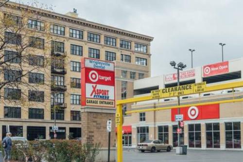 a gas station in front of a large building at Calm & Well-Equipped 2BR Chicago Apartment - Central Cozy in Dunning