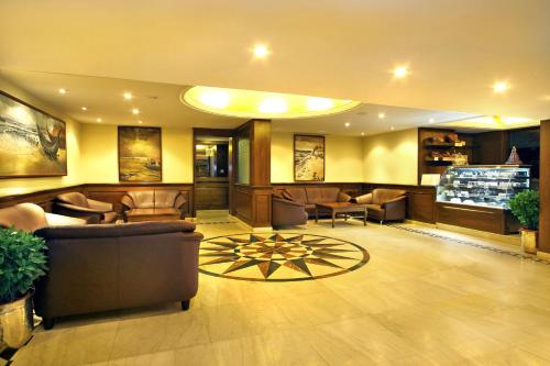 a lobby with couches and chairs in a building at The Sonnet Jamshedpur in Jamshedpur