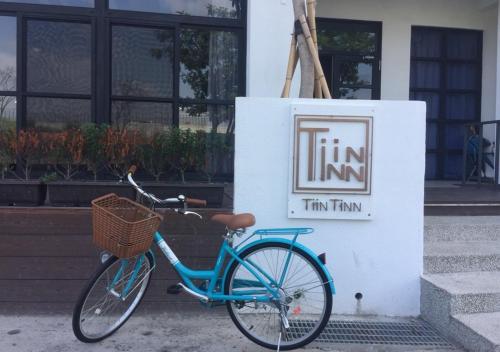 a blue bike parked in front of a sign at Tiin Tinn - Rivershore B&B in Taitung City
