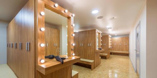 a locker room with wooden lockers and a mirror at Reston Hotel & Spa in Ulan-Ude