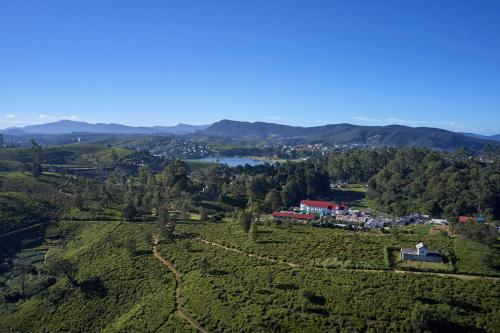 an aerial view of a house on a hill with a lake at Galway Heights Hotel in Nuwara Eliya