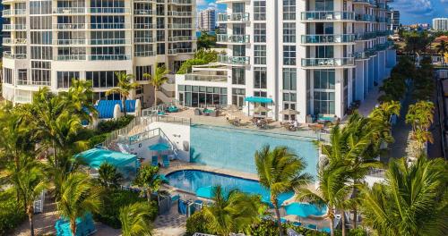 an aerial view of a resort pool with palm trees and buildings at Marenas Beach Resort in Miami Beach