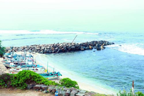 a group of boats parked on a beach at Hotel Sanmark in Ahangama