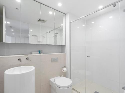 a bathroom with a toilet and a glass shower at Oracle Resort Broadbeach - gclr in Gold Coast