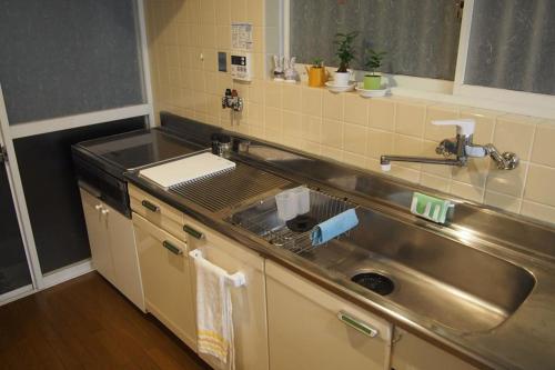 a kitchen with a sink and a counter top at Love Kyoto Kyoenkan in Kyoto