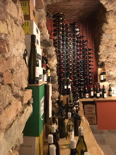 a room filled with lots of bottles of wine at OSTERIA al CANTONACCIO APARTMENTS in Brusimpiano