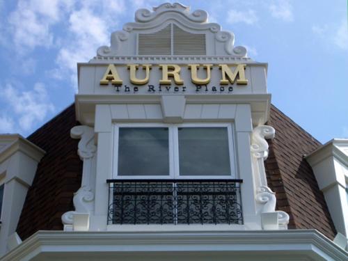 a sign on the top of a building with a balcony at Aurum The River Place in Bangkok