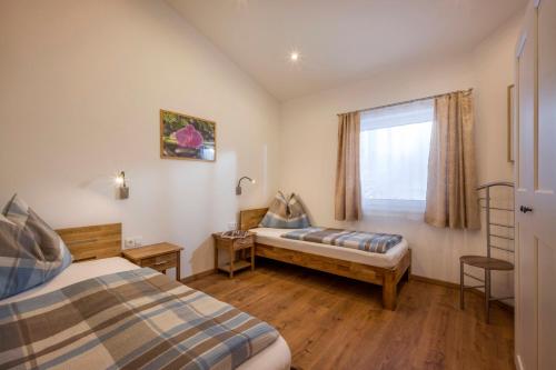 a bedroom with two beds and a window at Appartement Mühltal in Westendorf