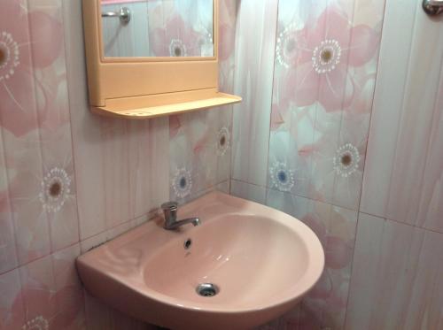a bathroom with a sink and a mirror at Saman Homestay in Tangalle