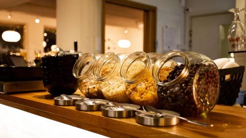 a group of glass dishes on a table with spoons at Hotel Vanha Rauma in Rauma