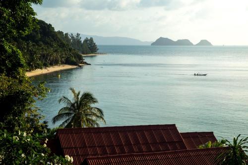 a view of a beach with a boat in the water at Zama Resort Koh Phangan in Haad Chao Phao